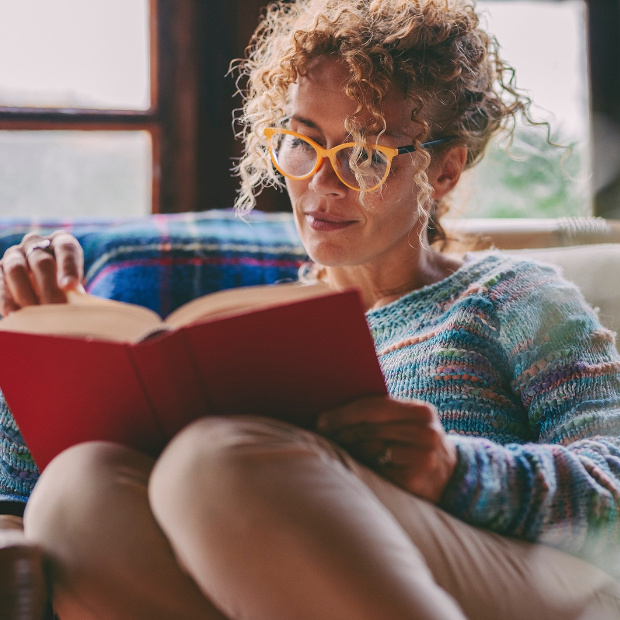 Woman At Home Sitting And Reading